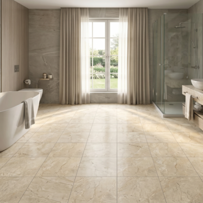 Baño espacioso con buena iluminación, bañera blanca y piso de cerámica mármol Roccia, colección Ecos de Cerámicos Gala